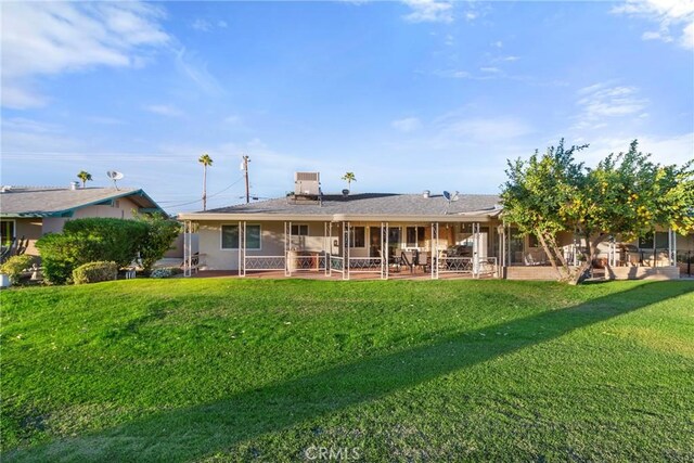 back of property featuring a lawn, a patio area, and central air condition unit