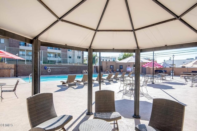 view of patio / terrace with a gazebo and a community pool