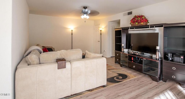 living room featuring light hardwood / wood-style flooring and ceiling fan