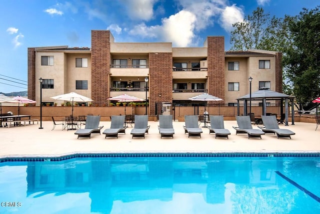 view of swimming pool featuring a gazebo