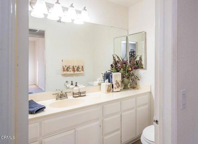 bathroom with vanity and toilet