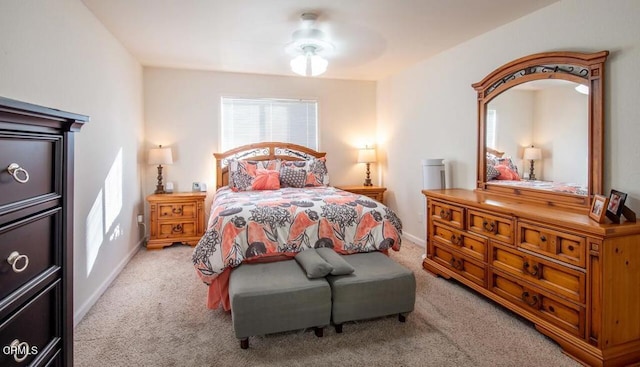 bedroom featuring light colored carpet and ceiling fan