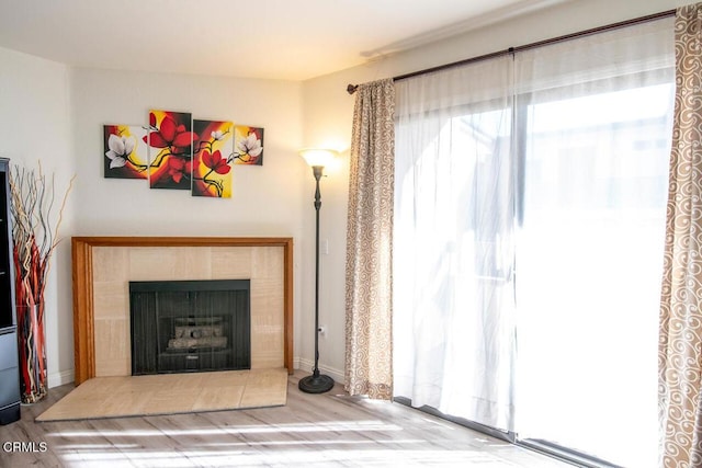 unfurnished living room with hardwood / wood-style flooring and a fireplace