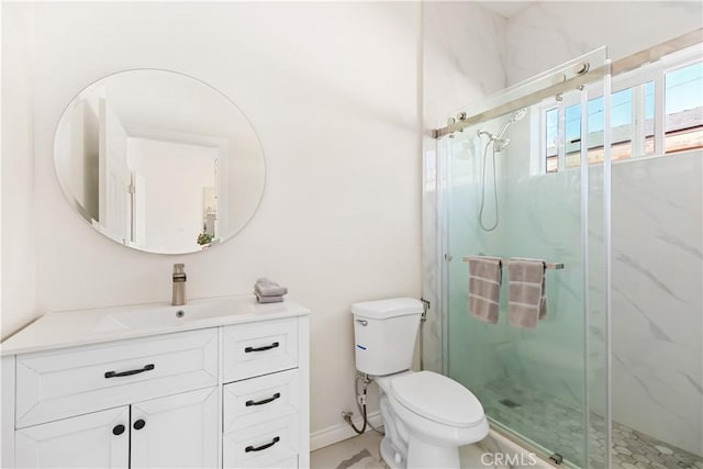 bathroom with vanity, toilet, and a shower with door