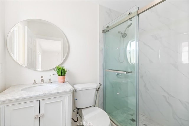 bathroom with vanity, an enclosed shower, and toilet