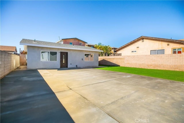 back of property with a patio