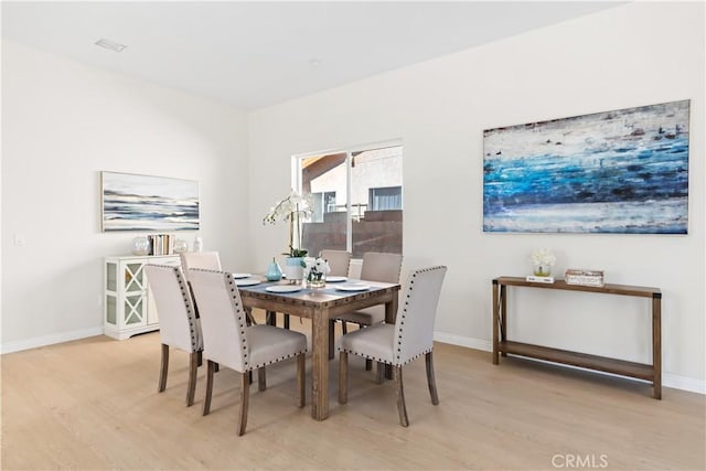 dining room with light hardwood / wood-style floors