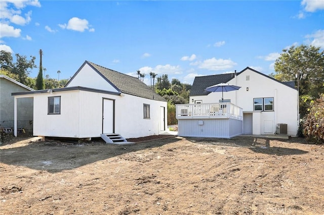 back of house with a wooden deck and cooling unit