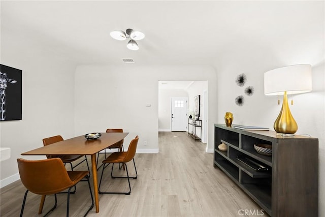 dining space with light hardwood / wood-style flooring