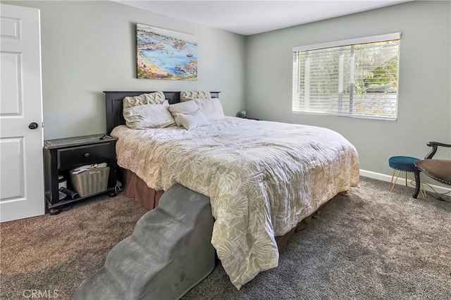 bedroom featuring dark carpet