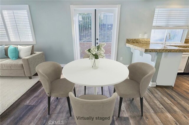 dining space with dark wood-type flooring and french doors