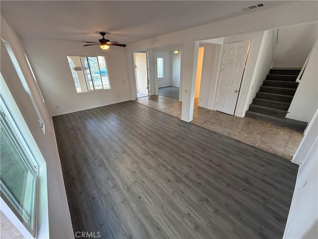 unfurnished living room featuring ceiling fan and hardwood / wood-style flooring