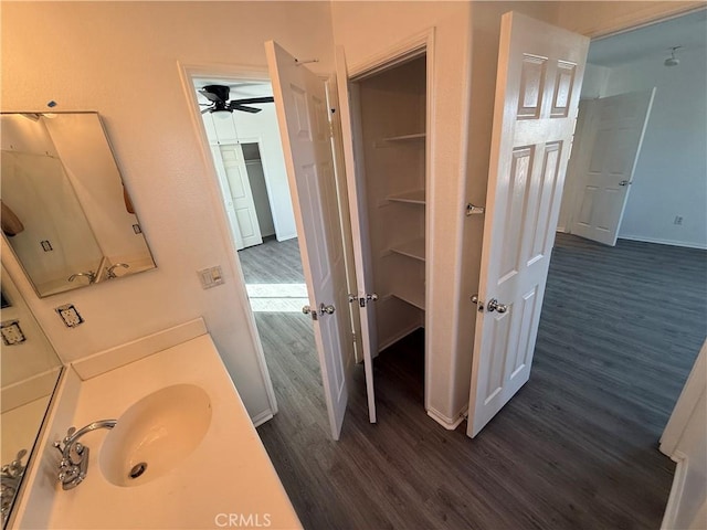 bathroom with hardwood / wood-style floors, vanity, and ceiling fan