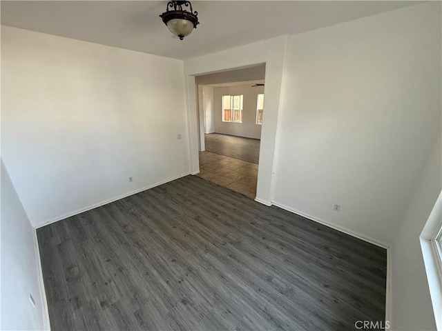 spare room featuring dark wood-type flooring