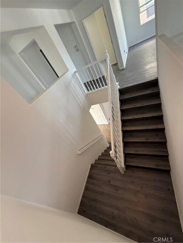 stairs featuring hardwood / wood-style flooring