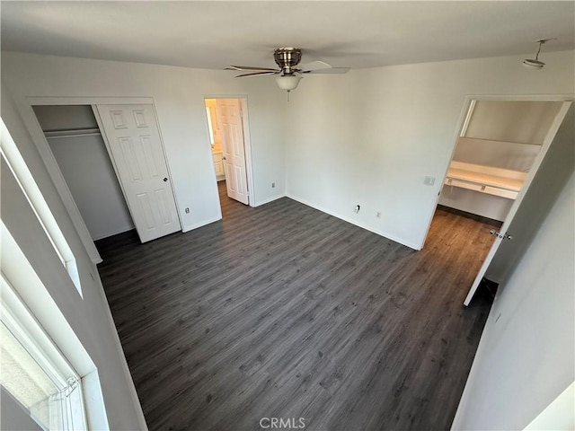 unfurnished bedroom featuring a closet, ceiling fan, and dark wood-type flooring