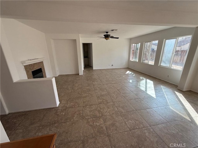 unfurnished living room featuring ceiling fan and light tile patterned flooring