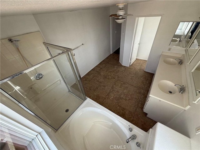 bathroom featuring ceiling fan, vanity, a textured ceiling, and independent shower and bath