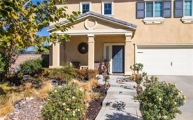 view of exterior entry with a garage