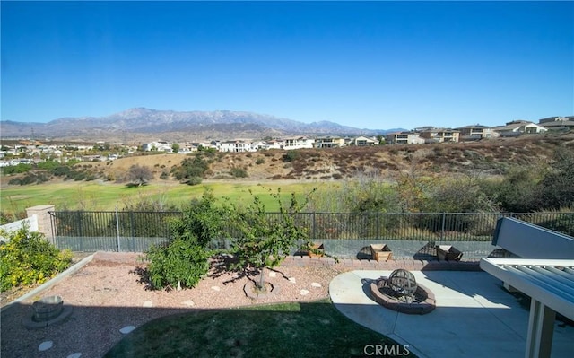 view of yard with a mountain view, a fire pit, and a patio area