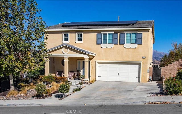 view of front facade with solar panels and a garage