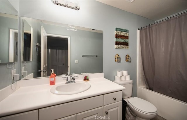 full bathroom with vanity, shower / bath combo, and toilet