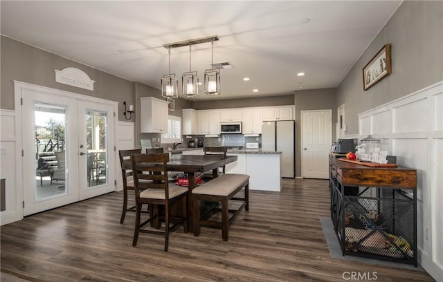 dining area featuring french doors, dark hardwood / wood-style floors, and sink