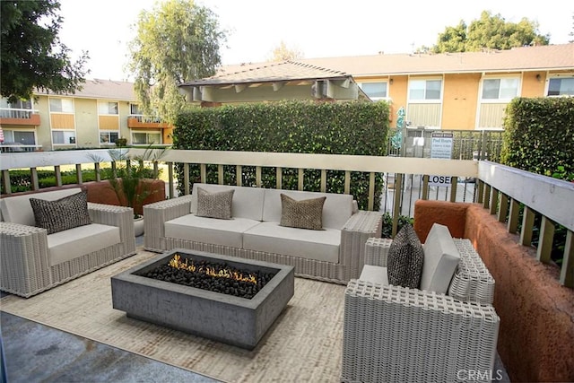 balcony with an outdoor living space with a fire pit