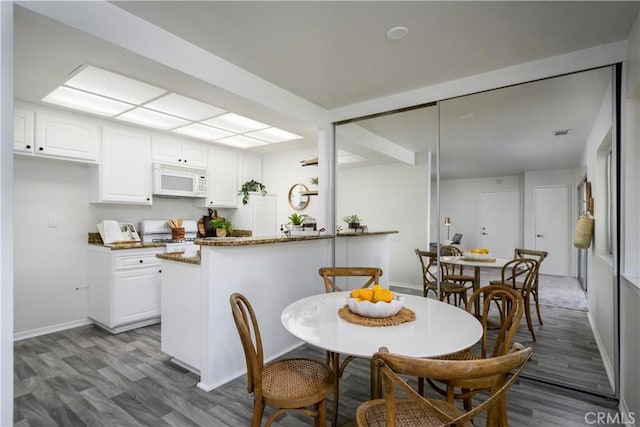 dining area with light hardwood / wood-style floors