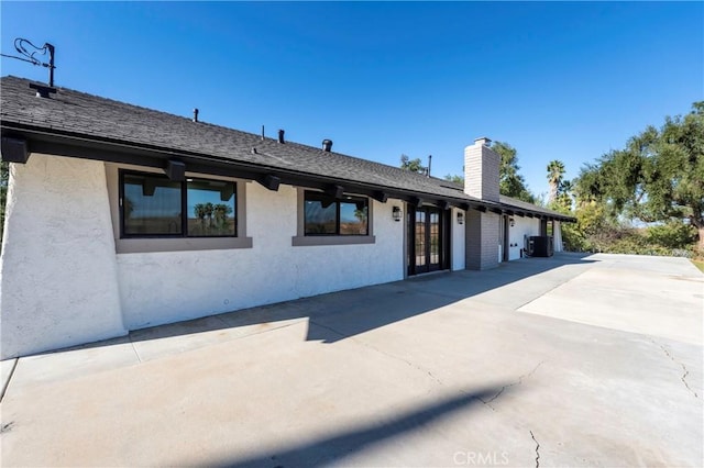 ranch-style house featuring a patio area and central air condition unit