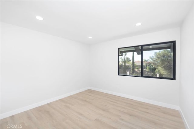 spare room featuring light wood-type flooring