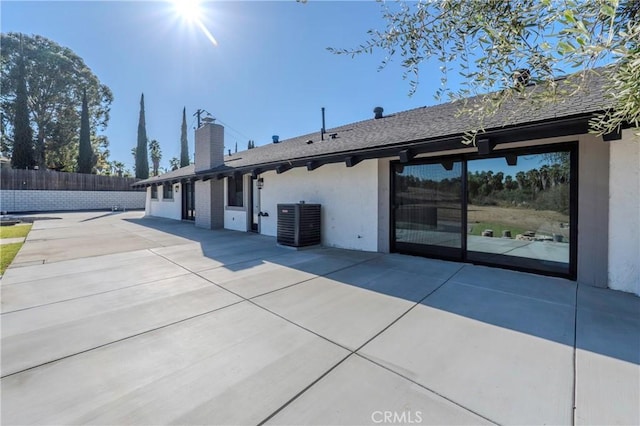 rear view of property featuring a patio area and central AC