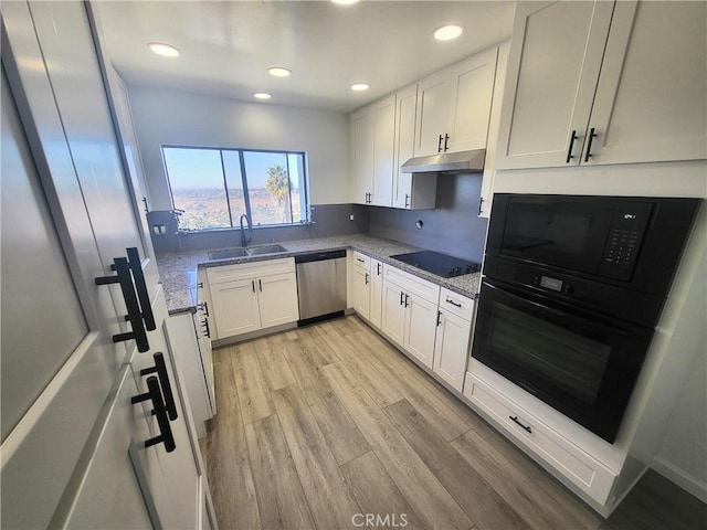 kitchen with white cabinetry, sink, black appliances, and stone countertops