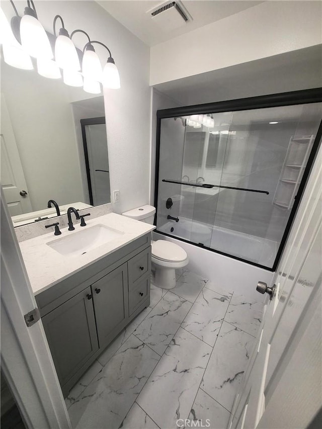 full bathroom with enclosed tub / shower combo, vanity, and toilet