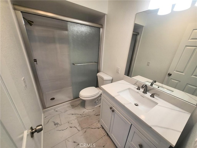 bathroom with vanity, an enclosed shower, and toilet