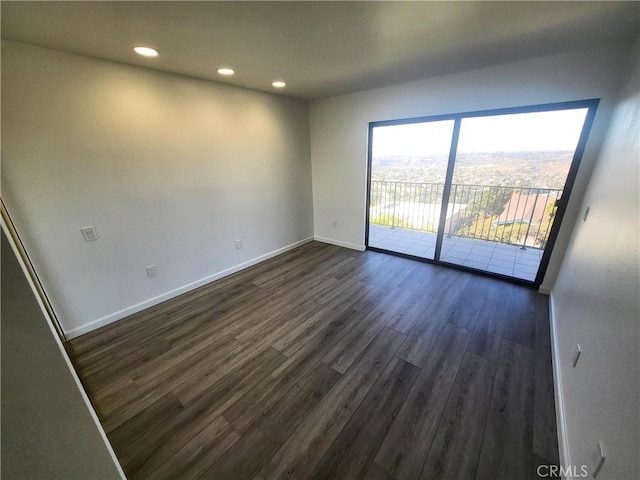 spare room featuring dark wood-type flooring