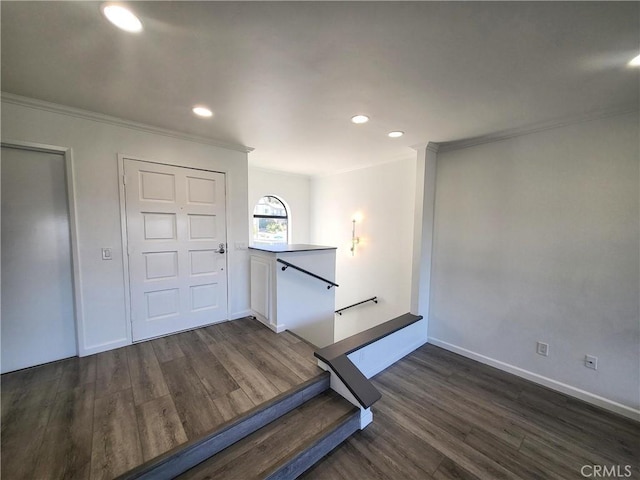 workout room featuring dark hardwood / wood-style flooring and ornamental molding