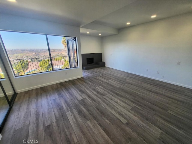 unfurnished living room featuring dark wood-type flooring