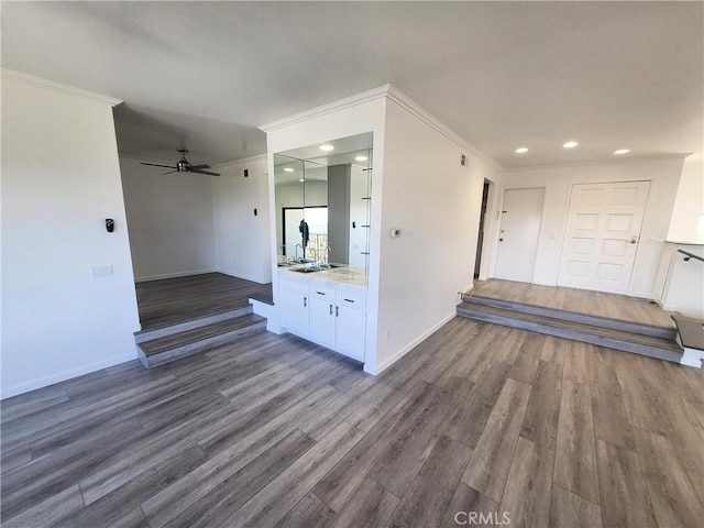 interior space featuring crown molding, dark wood-type flooring, and ceiling fan