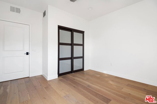 empty room with light hardwood / wood-style flooring