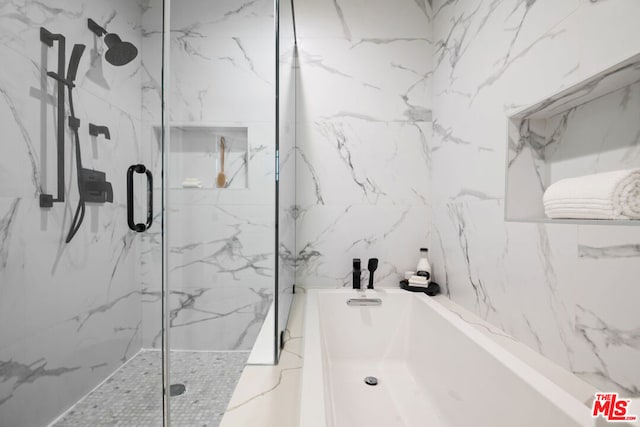 bathroom featuring separate shower and tub