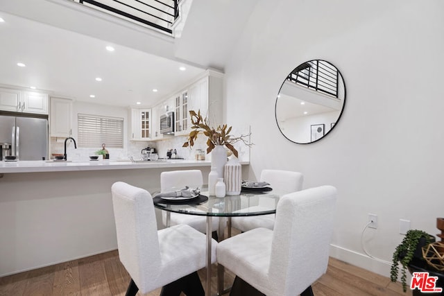 dining space with light hardwood / wood-style floors