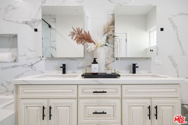 bathroom featuring decorative backsplash, a shower with shower door, and vanity