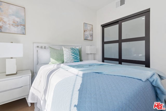 bedroom with dark wood-type flooring