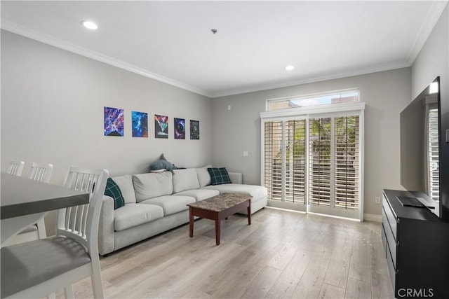 living room with light hardwood / wood-style flooring and ornamental molding