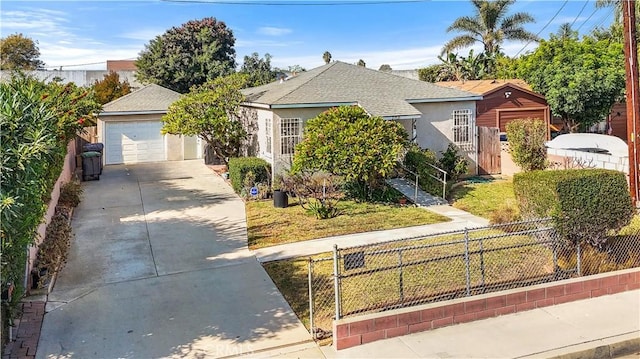 view of front of property featuring a garage and a front lawn