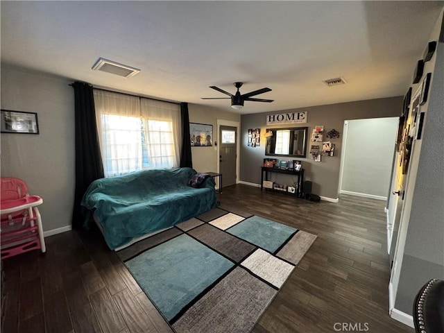 bedroom with ceiling fan and dark wood-type flooring