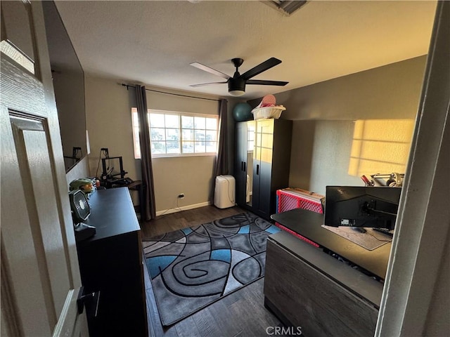 bedroom with ceiling fan and dark hardwood / wood-style floors