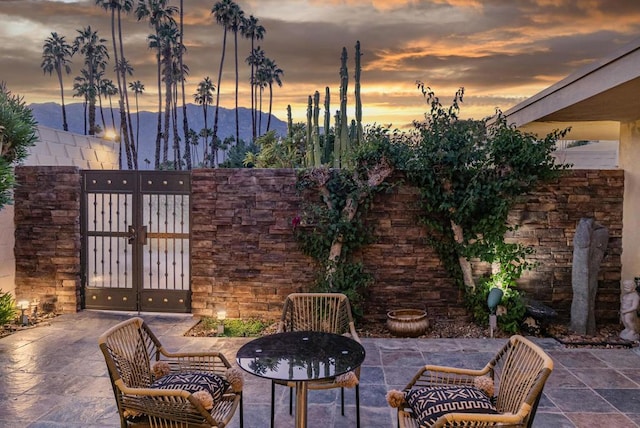 patio terrace at dusk with a mountain view