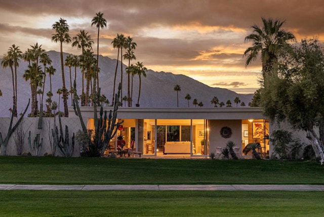 view of front facade with a mountain view and a yard